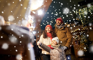 Image showing happy family at christmas market in city