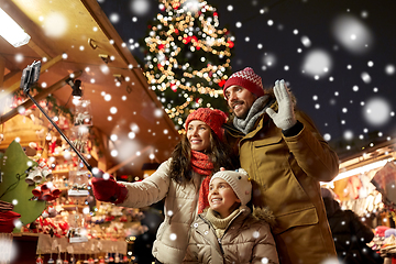 Image showing happy family taking selfie at christmas market