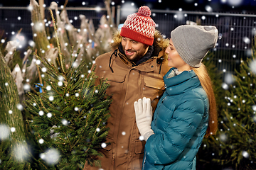 Image showing happy couple buying christmas tree at market