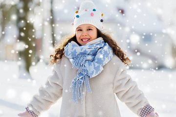 Image showing happy little girl in winter clothes outdoors