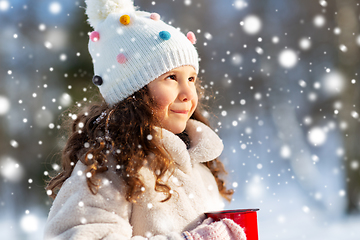 Image showing little girl with cup of hot tea in winter park