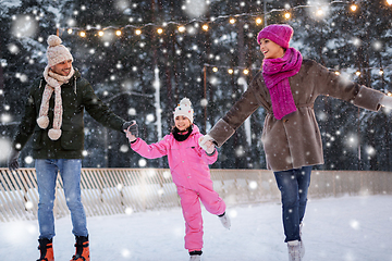 Image showing happy family at outdoor skating rink in winter