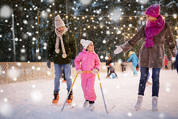 Image showing happy family at outdoor skating rink in winter