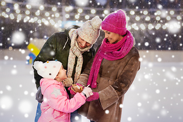 Image showing happy family eating pancakes on skating rink