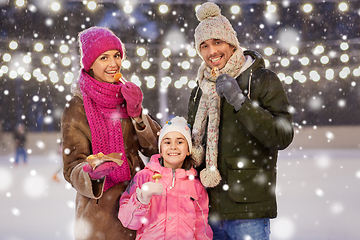 Image showing happy family eating pancakes on skating rink