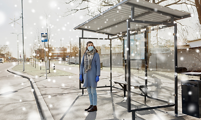 Image showing young woman wearing medical mask at bus stop