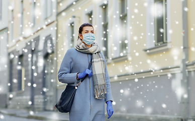 Image showing young woman wearing protective medical mask