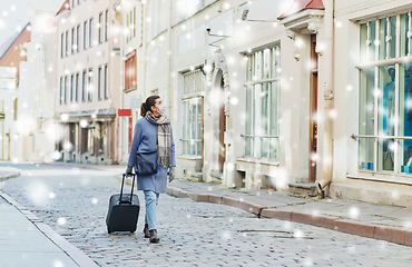 Image showing woman in protective mask with travel bag in city