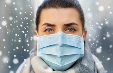 Image showing young woman wearing protective medical mask