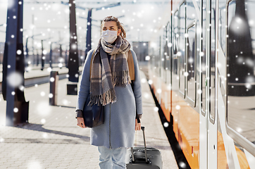 Image showing woman in protective face mask at railway station