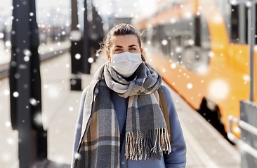 Image showing woman in protective face mask at railway station