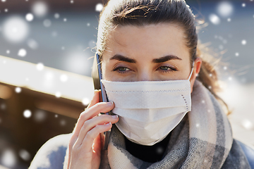 Image showing woman in face mask calling on smartphone in city