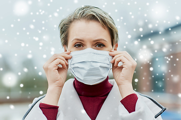 Image showing young woman wearing protective medical mask