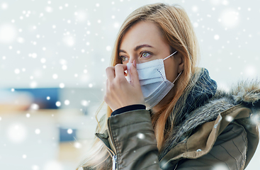 Image showing young woman wearing protective medical mask