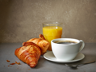 Image showing cup of coffee and croissants