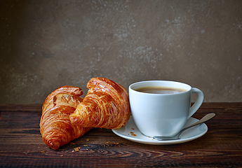 Image showing cup of coffee and croissants