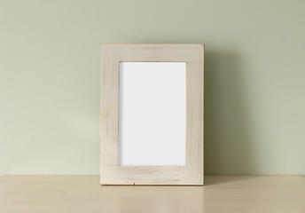 Image showing empty frame on green wall background