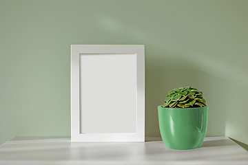 Image showing empty frame and green flower pot