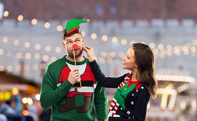 Image showing couple with christmas party props in ugly sweaters