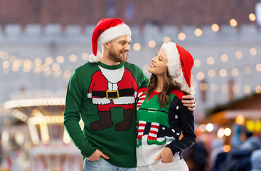 Image showing happy couple in ugly sweaters on christmas