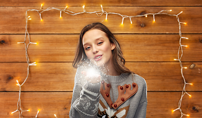 Image showing woman in ugly christmas sweater with magical dust