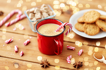 Image showing cup of eggnog with candy cane, cookies and sugar