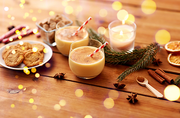 Image showing glasses of eggnog, oatmeal cookies and fir branch