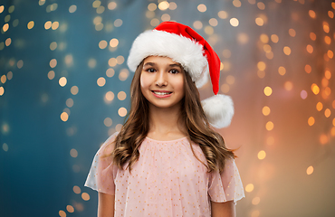 Image showing happy teenage girl in santa hat on christmas