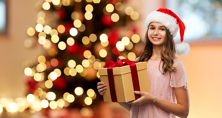 Image showing teenage girl in santa hat with christmas gift