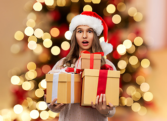 Image showing teenage girl in santa hat with christmas gift