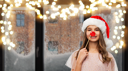 Image showing happy teenage girl in santa hat on christmas