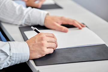 Image showing close up of businessman with paper at office