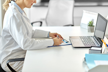 Image showing doctor with laptop and medical report at hospital