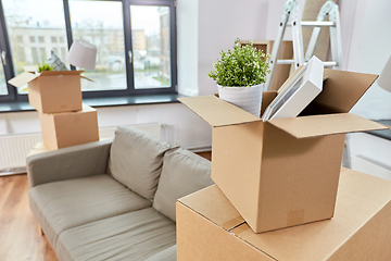 Image showing sofa and corrugated boxes with stuff at new home