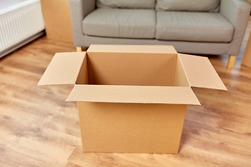 Image showing empty corrugated box and sofa at new home