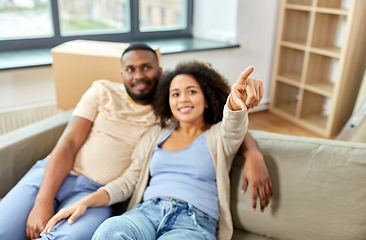 Image showing happy couple with boxes moving to new home