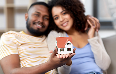 Image showing happy couple with house model moving to new home