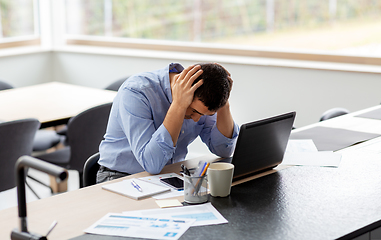 Image showing stressed man with laptop working at home office