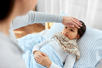 Image showing mother measuring temperature of sick daughter