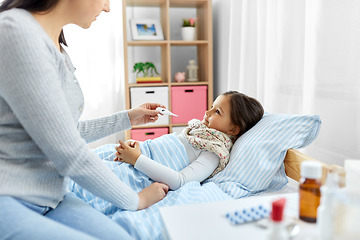 Image showing mother measuring temperature of sick daughter