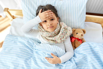 Image showing sick girl lying in bed at home