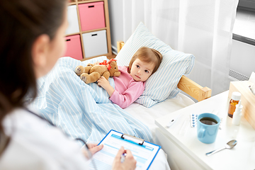 Image showing doctor with clipboard and sick girl in bed at home