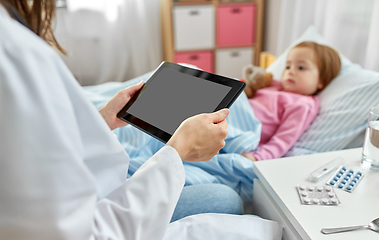 Image showing doctor with tablet computer and sick girl in bed