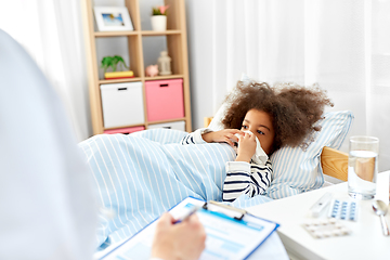 Image showing doctor with clipboard and sick girl in bed at home