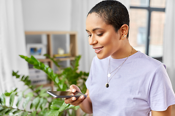 Image showing african american woman with smartphone at home