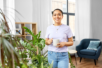 Image showing african american woman drinking coffee at home