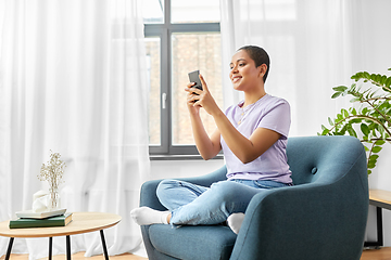 Image showing african american woman with smartphone at home