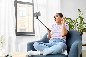 Image showing happy african american woman taking selfie at home