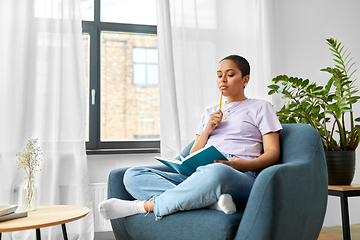 Image showing african american woman with diary at home