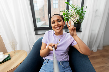 Image showing happy african american woman taking selfie at home